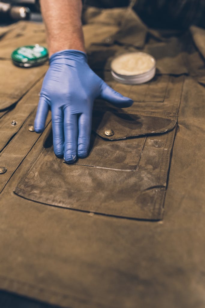 applying wax to pocket of jacket
