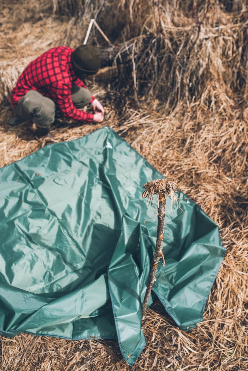 tying down the rear corners of green tarp